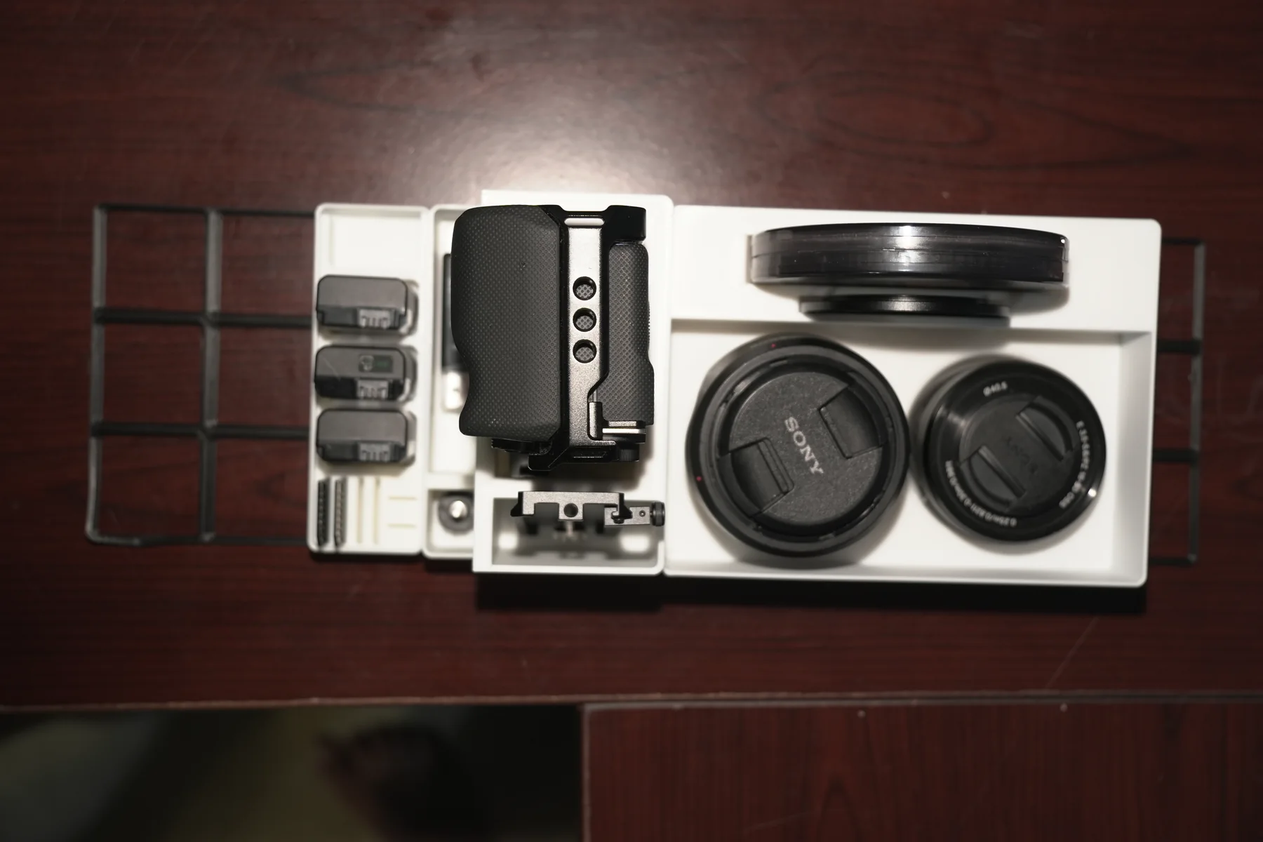 Camera kit arranged in its white 3D-printed storage modules