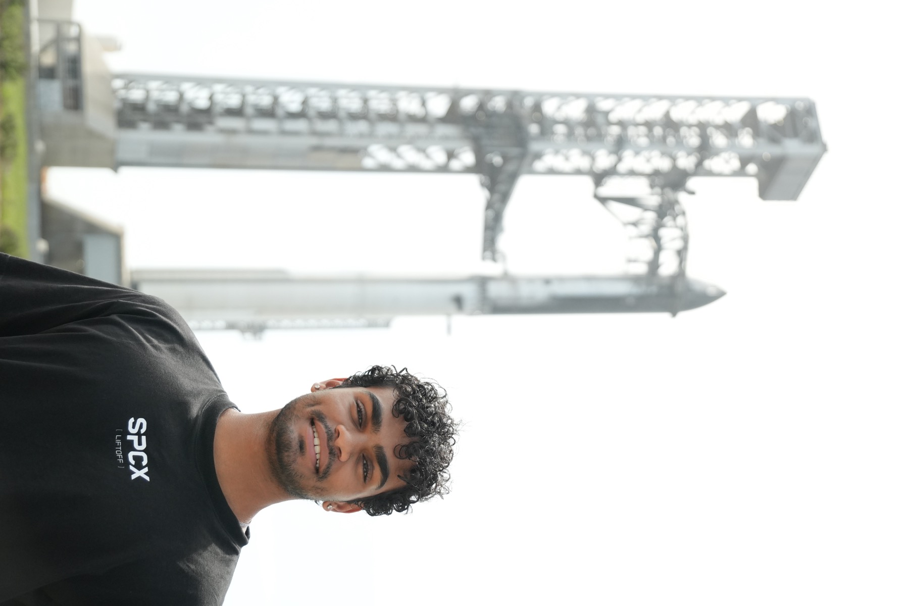 Josh standing in front of Starship and the launch tower.
