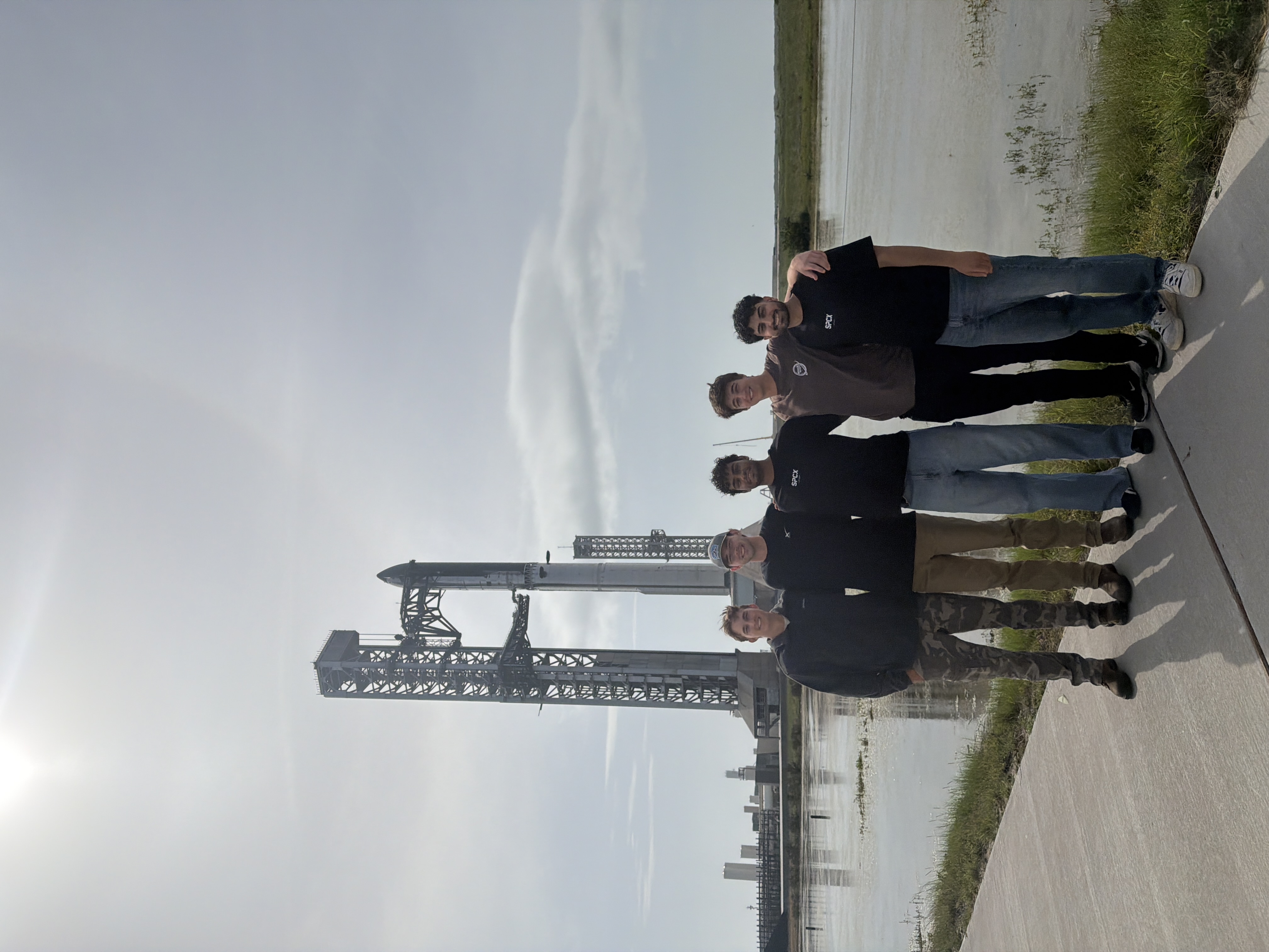 Josh with fellow interns in front of Starship at the SpaceX site.