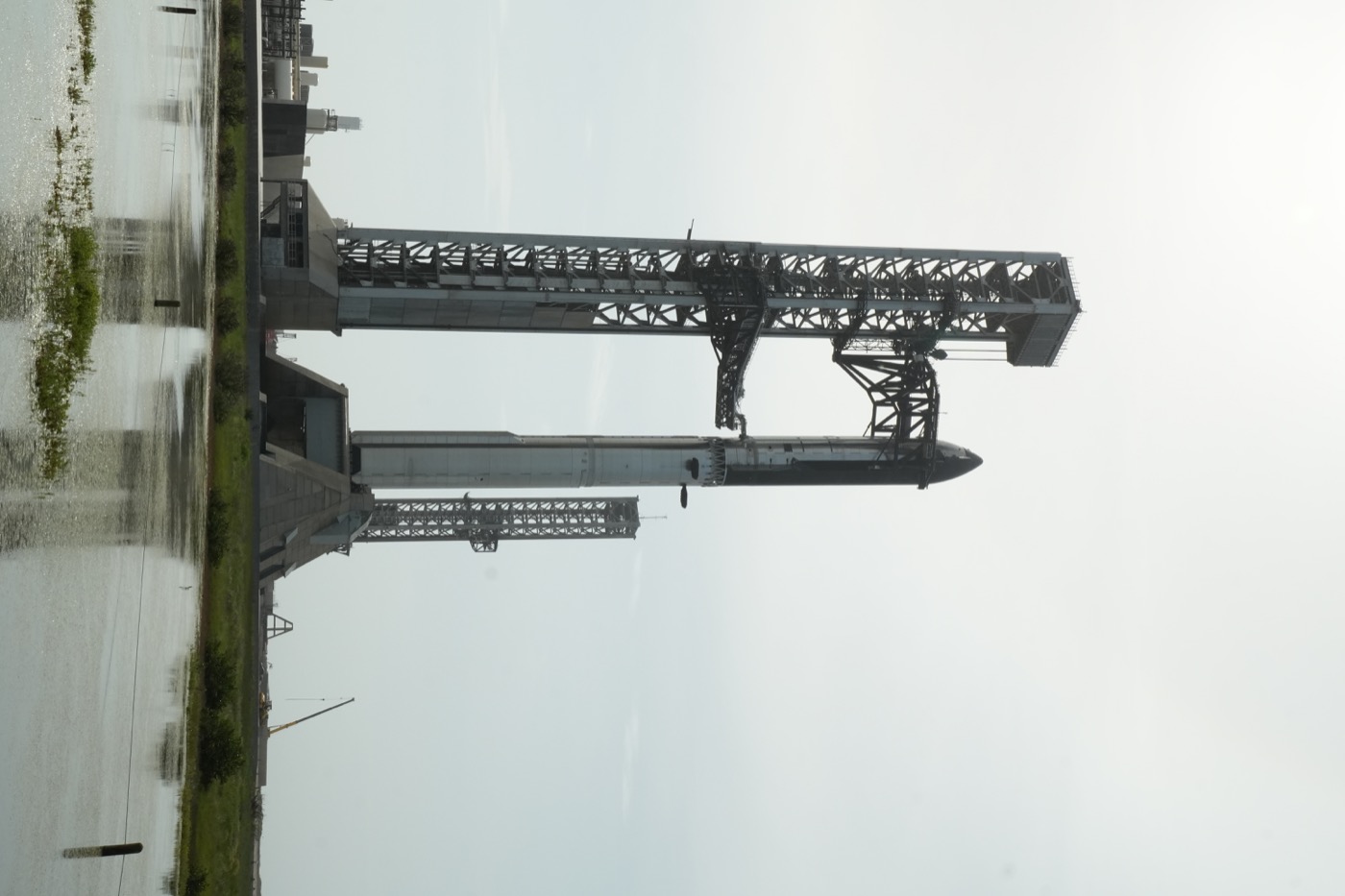 Starship vehicle and launch tower at the SpaceX site.